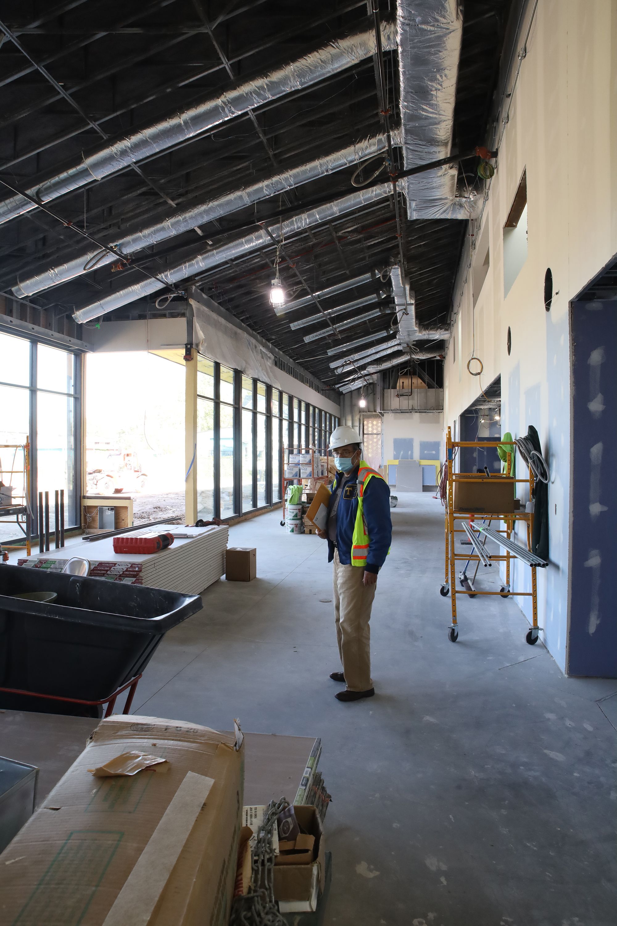 Br. David Preuss inspects progress inside the future gift shop and On the Rise Cafe at the Solanus Casey Center