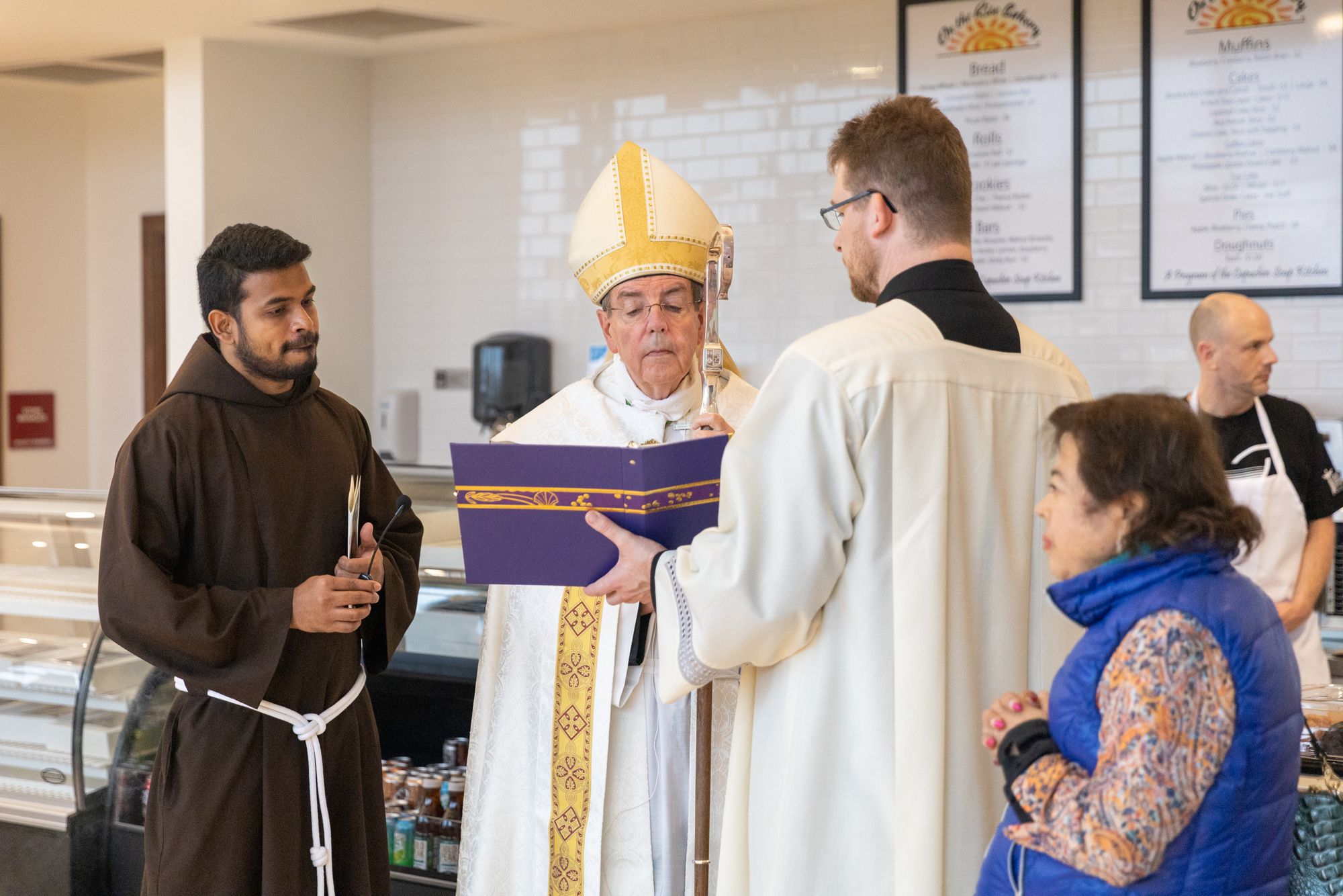 Archbishop offers a blessing in the new café.
