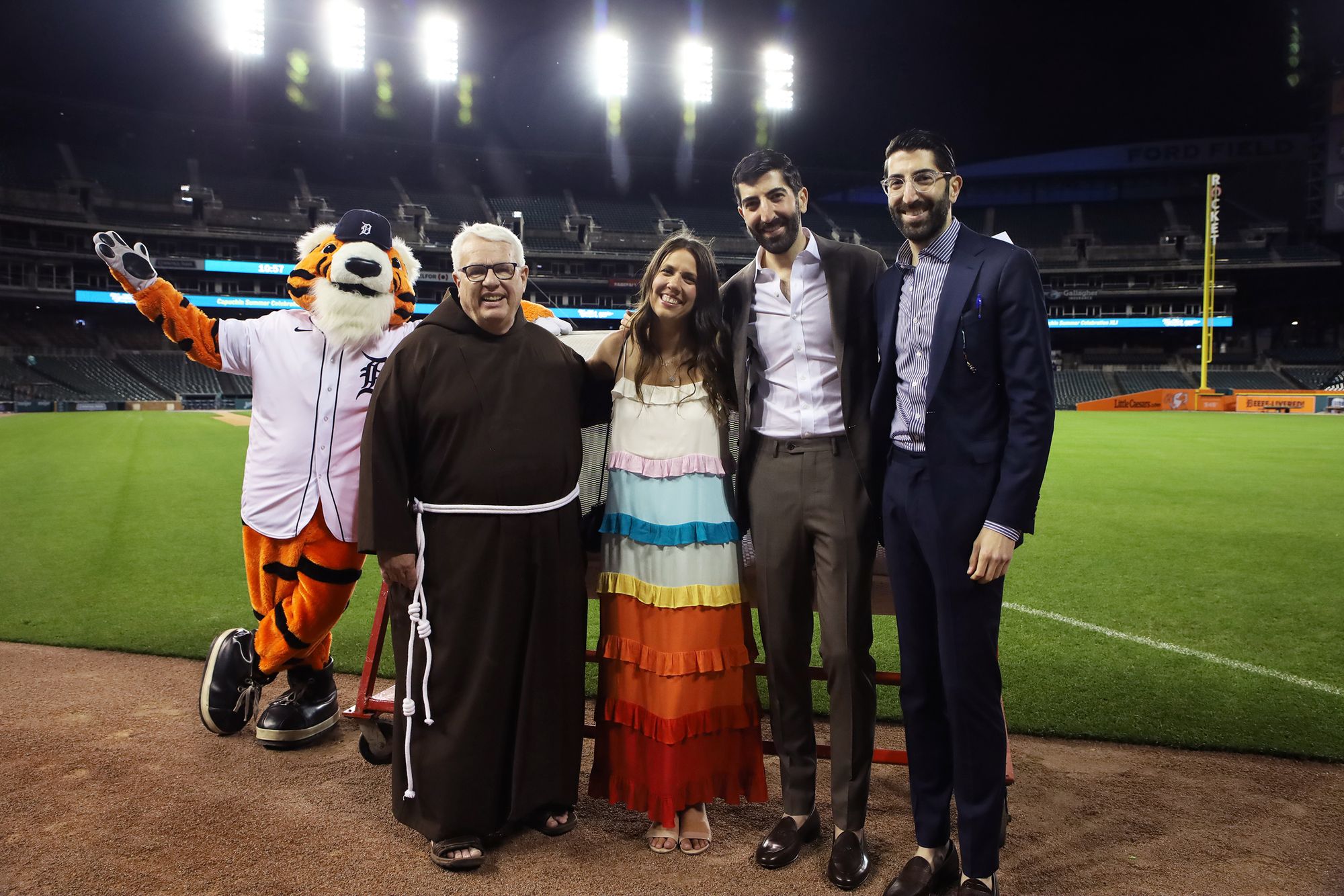 Detroit Tigers mascot Paws, Br. Gary Wegner and the Ahee family on the field at Comerica Park