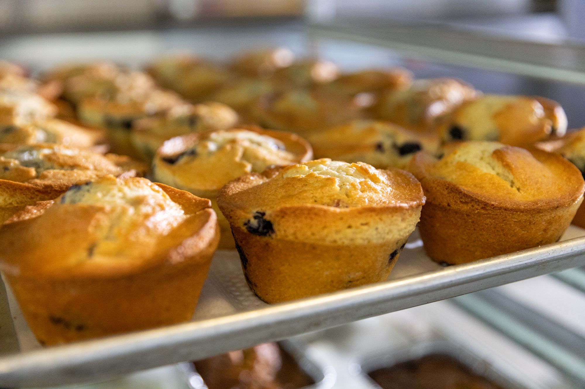 Fresh blueberry muffins cool after coming out of the oven at On the Rise Bakery in Detroit.