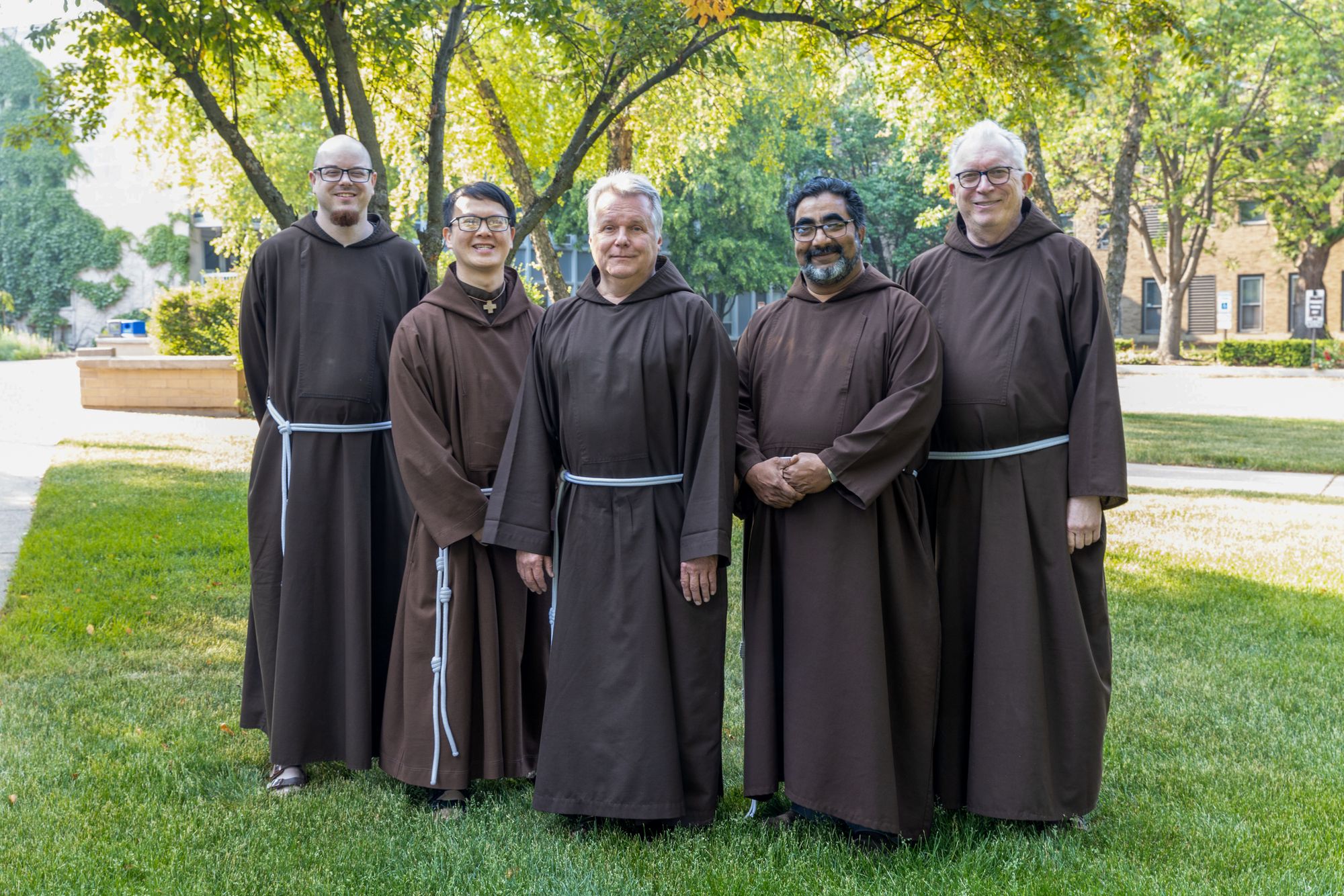 Exterior color photograph of the newly-elected Provincial Council. From Left: Friars Nicholas Blattner, Tien Dinh, Mark Joseph Costello, Biju Parakkalayil and William Hugo.