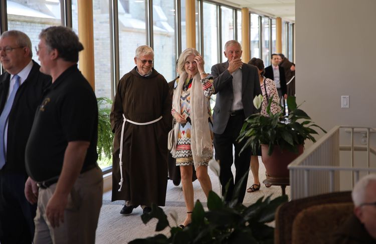 Color landscape photo of friars and guests arriving at the Capuchin Center in Milwaukee for the First Annual Questors Club.